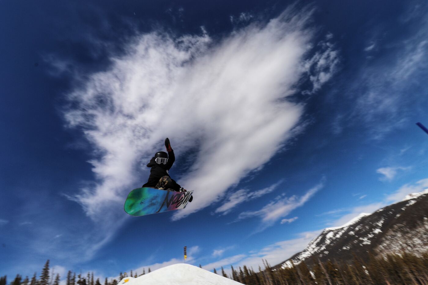 A rider mid air against a bright sky